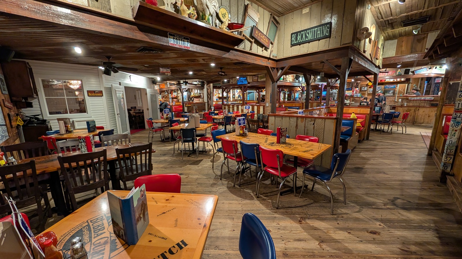 Wood-paneled dining room with colorful tables inside Bubba Gump Shrimp Co. Orlando