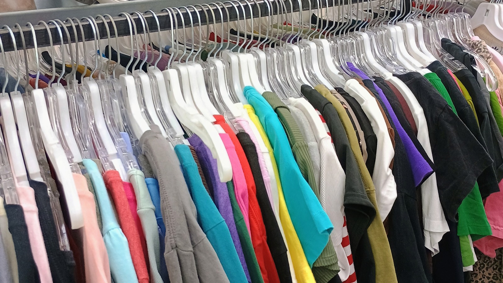 Neatly arranged shirt rack at Texas Thrift Store in Harlingen