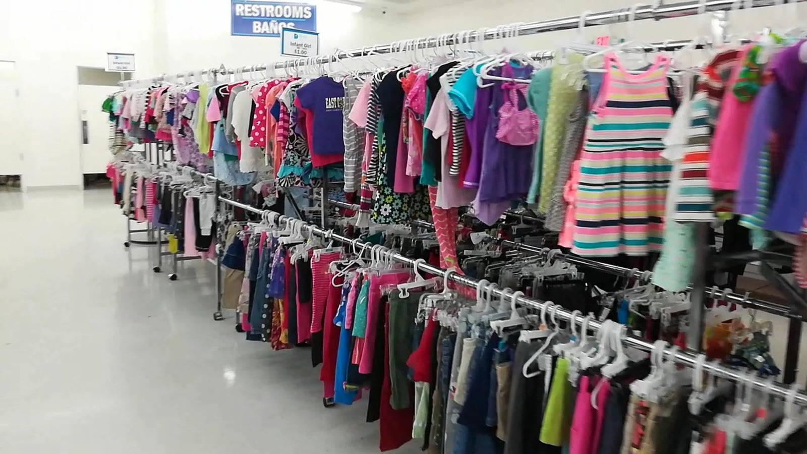 Colorful clothing racks inside Dorcas Thrift Shop in Cary