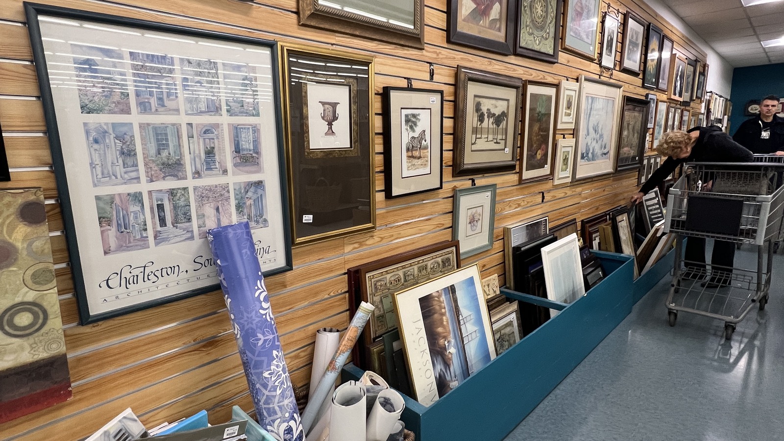 Framed artwork arranged inside Dorcas Thrift Shop in Cary
