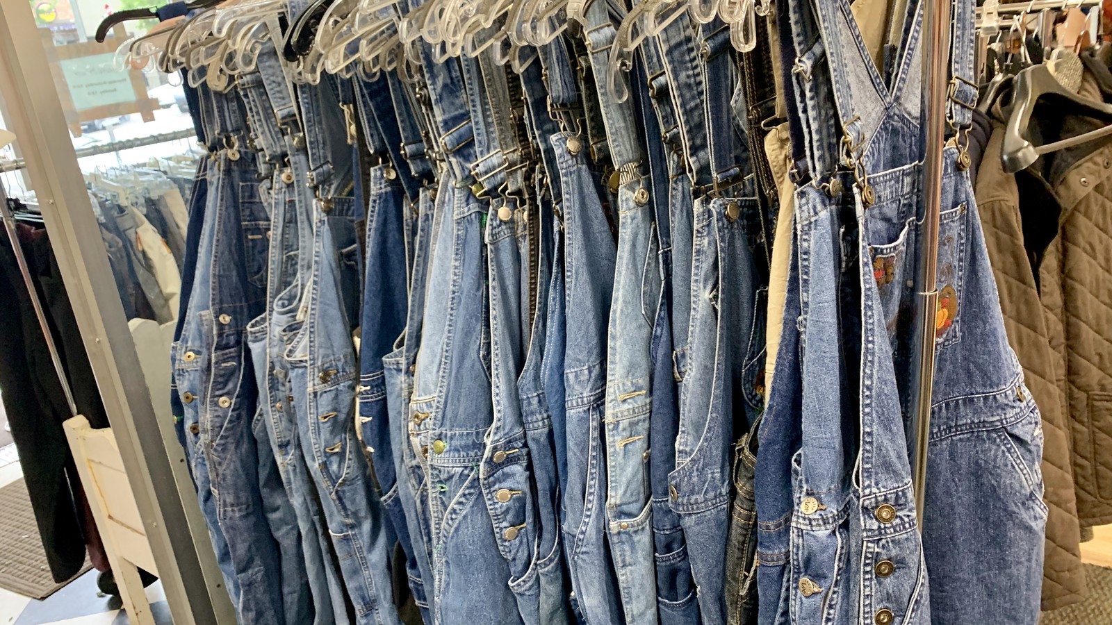 Rows of vintage and secondhand denim hanging inside Brand Spanking Used in Fort Collins