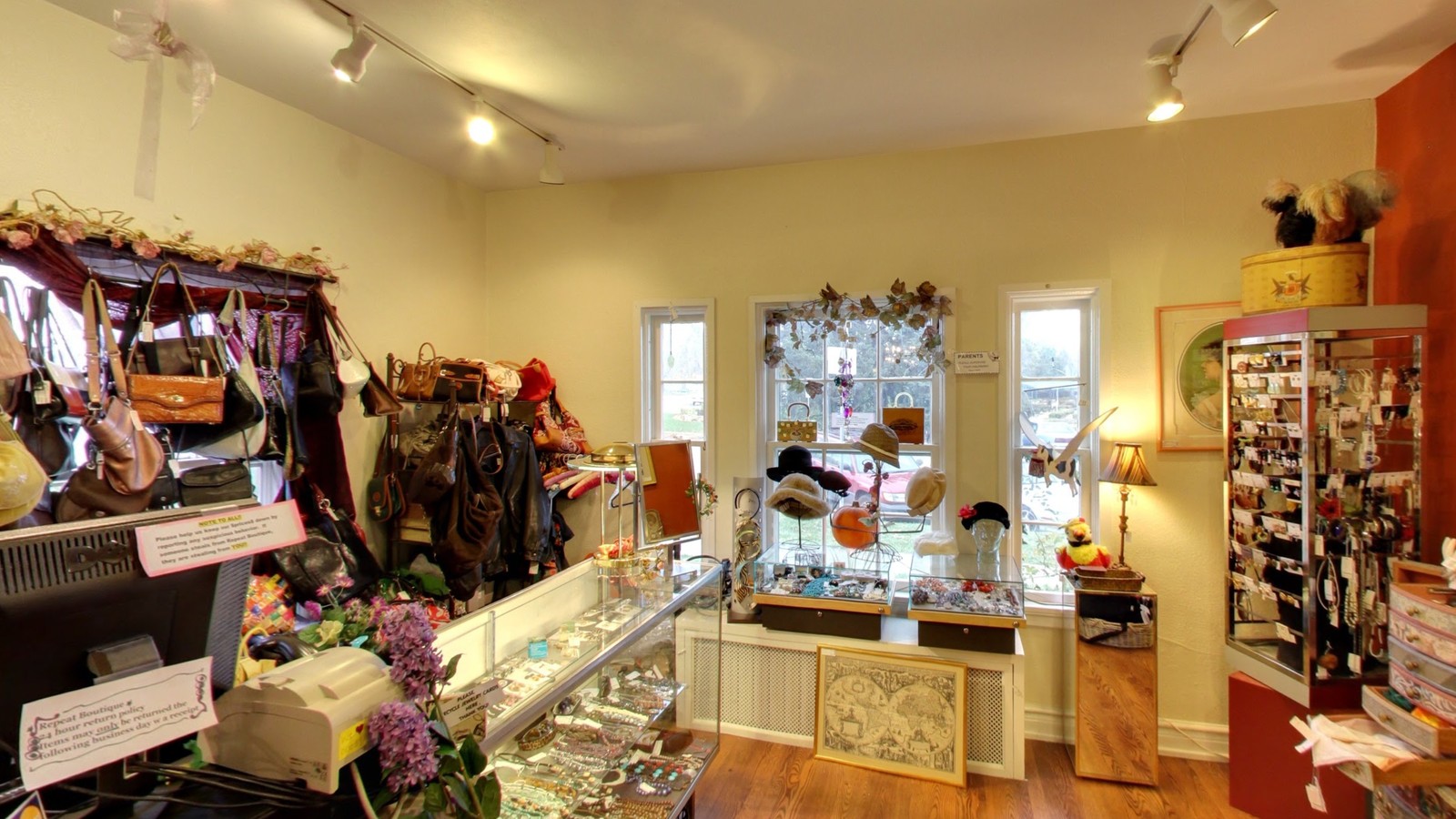 Jewelry cases, clothing racks, and colorful boutique displays inside Repeat Boutique in Fort Collins