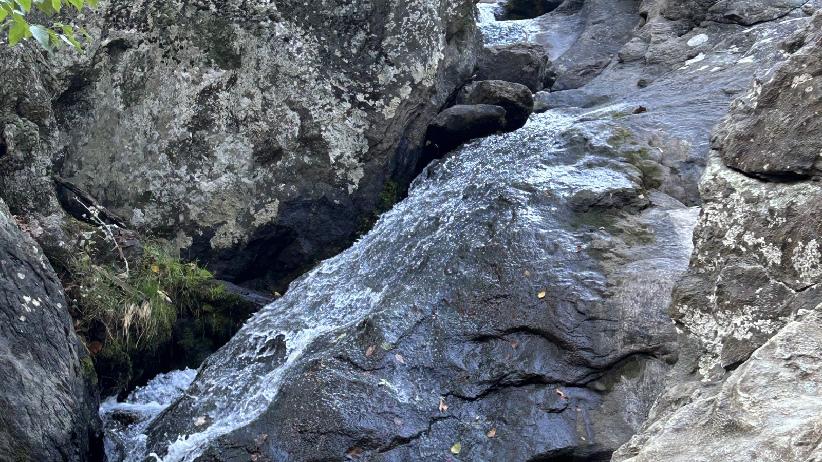 Water sliding down the rock face of Cunningham Falls between large boulders