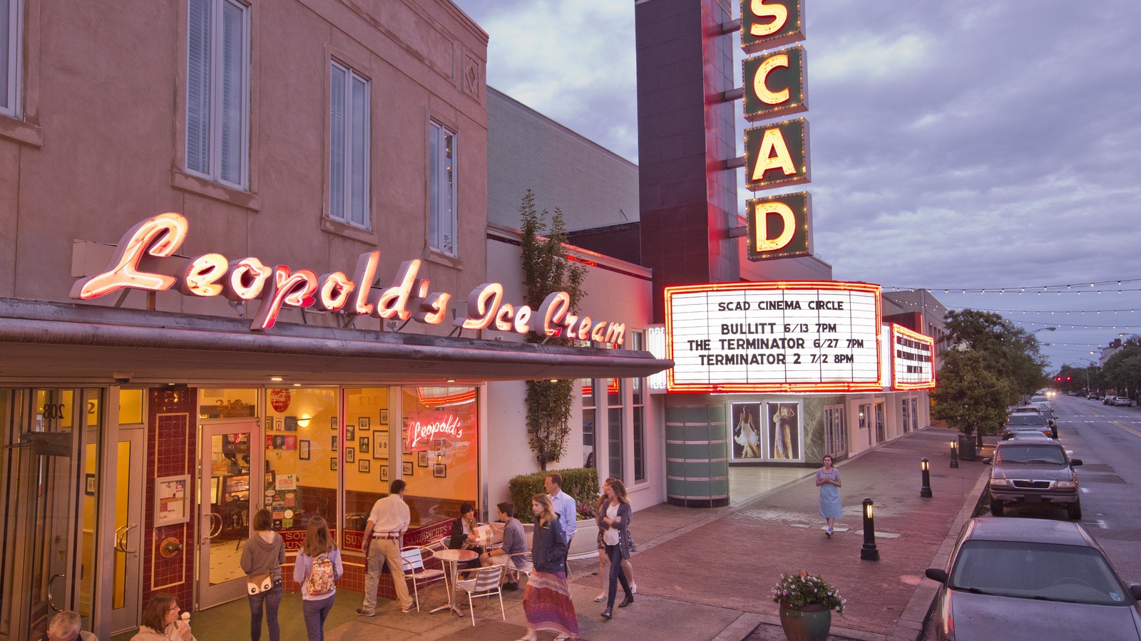 Leopold's Ice Cream glowing beside the SCAD Cinema marquee on Broughton Street at dusk