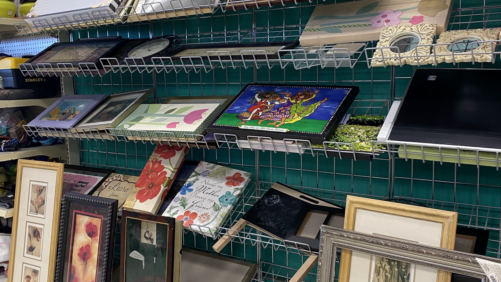 Wall art and framed decor shelves inside Texas Thrift Killeen