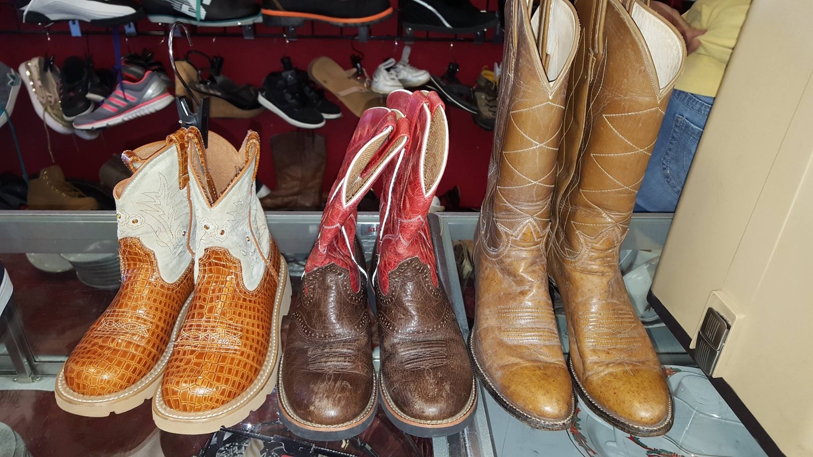 Cowboy boots lined up on a shelf inside Texas Thrift Killeen