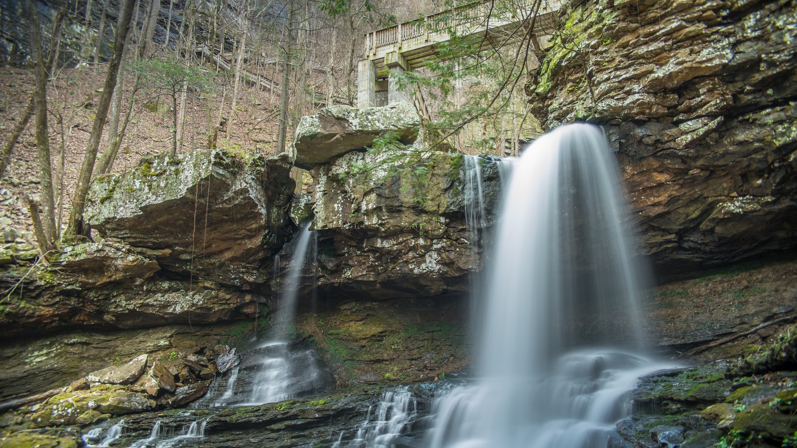 Cherokee Falls beside a boulder-filled creek and bridge at Cloudland Canyon State Park.