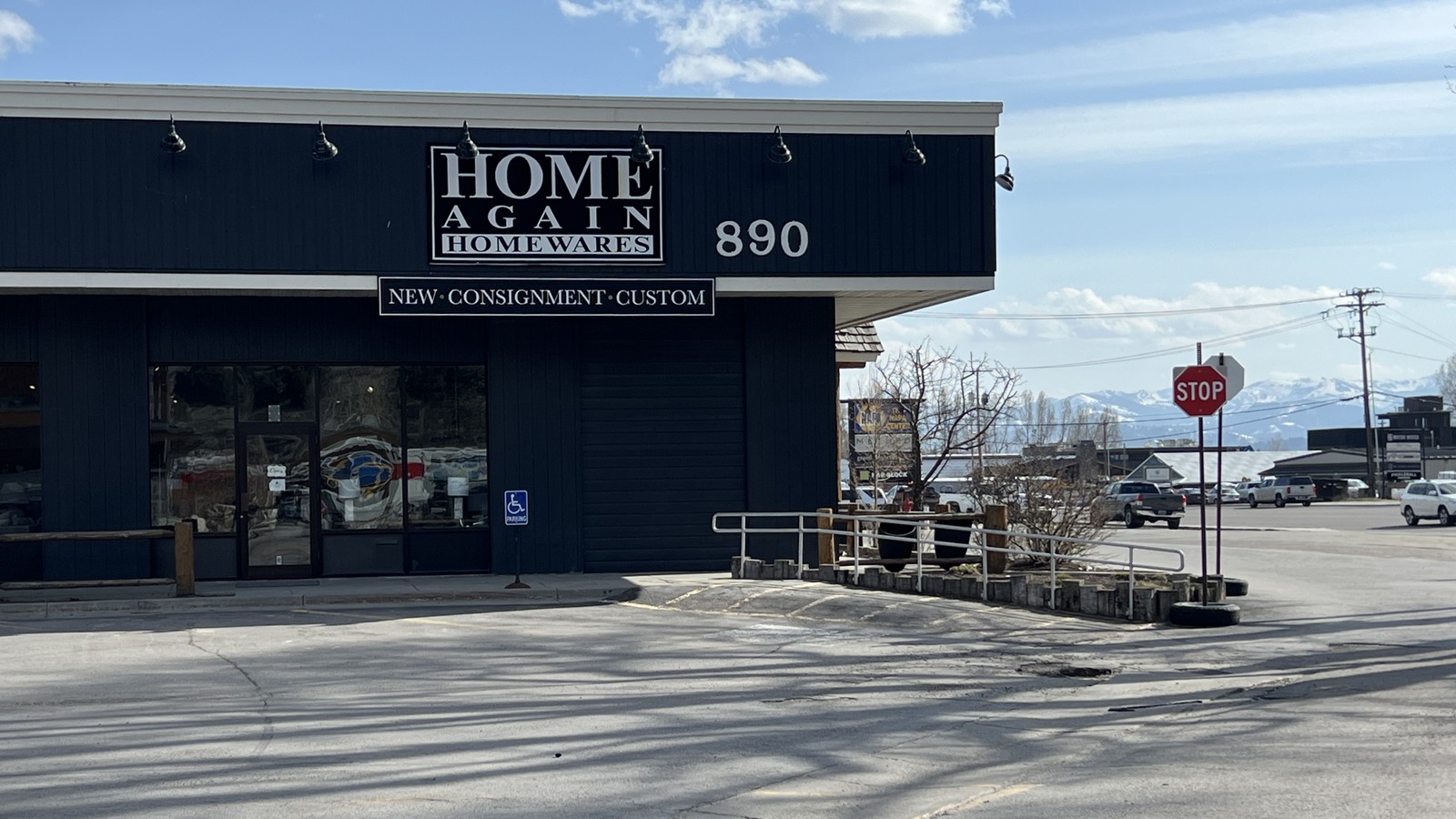 Home Again consignment homewares storefront with Wyoming mountains beyond