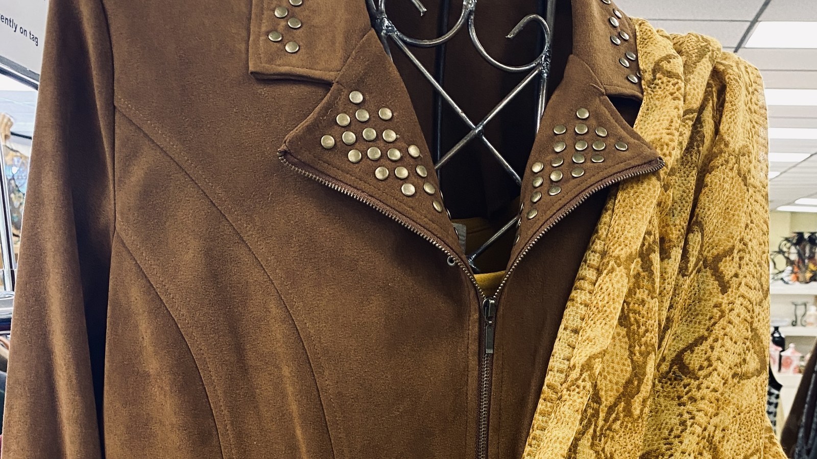 Vintage leather jacket and patterned clothing at Ladies Of Charity Thrift Store in Chattanooga