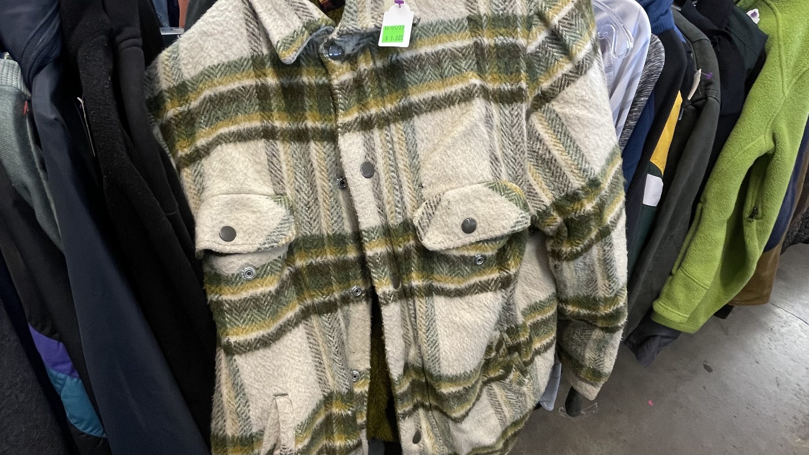 Plaid jacket among clothing racks at Community Thrift Shop in Pendleton Oregon