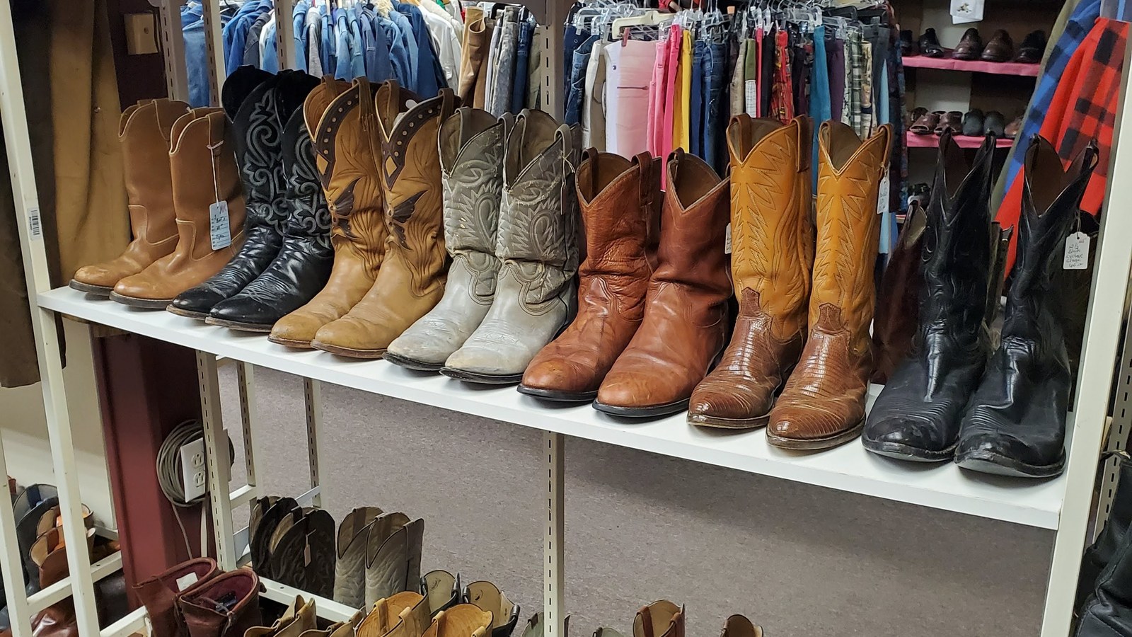 Vintage western boots lined on shelves at ReRide in Pendleton Oregon