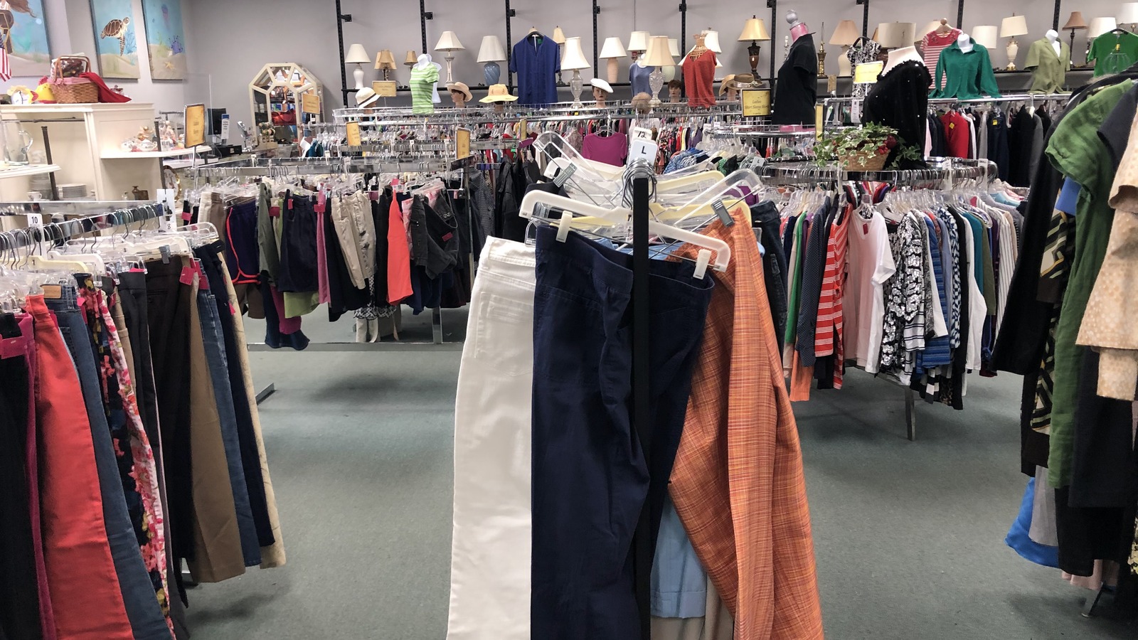 Clothing racks and lamps inside VNA Hidden Treasures in Vero Beach