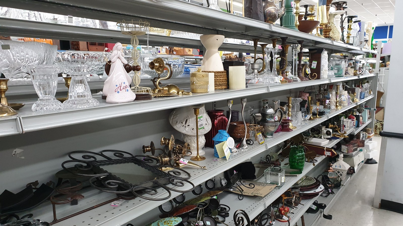Glassware lamps and decorative pieces arranged on shelves at 2nd Ave Laurel