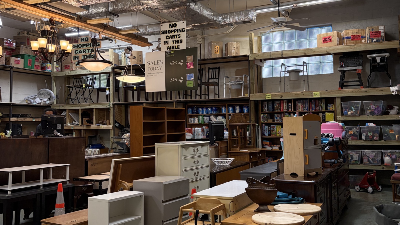 Furniture, shelving, and lamps across the showroom at New Life Thrift in Glenside