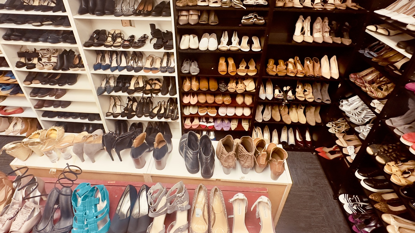 Shelves filled with shoes in the footwear room at New Life Thrift in Glenside
