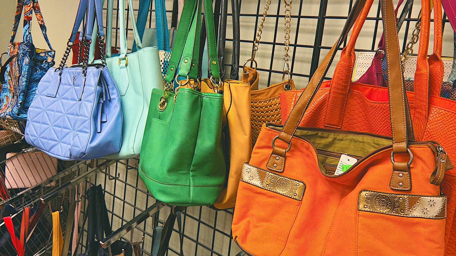Colorful handbags hanging together at New Life Thrift in Glenside