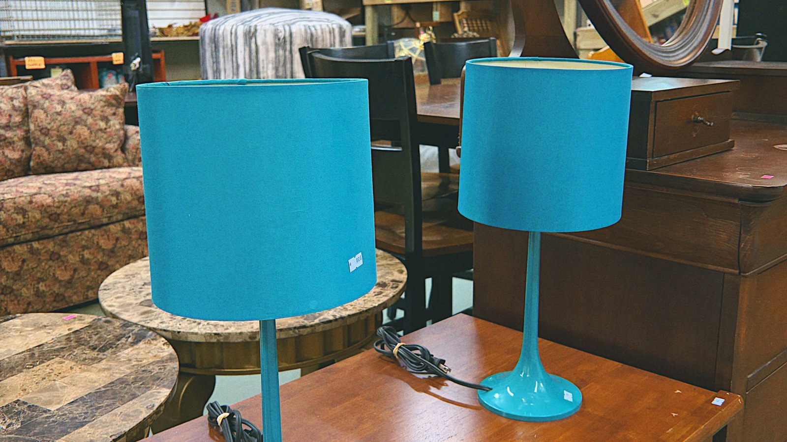 Pair of bright blue table lamps among home furnishings at New Life Thrift