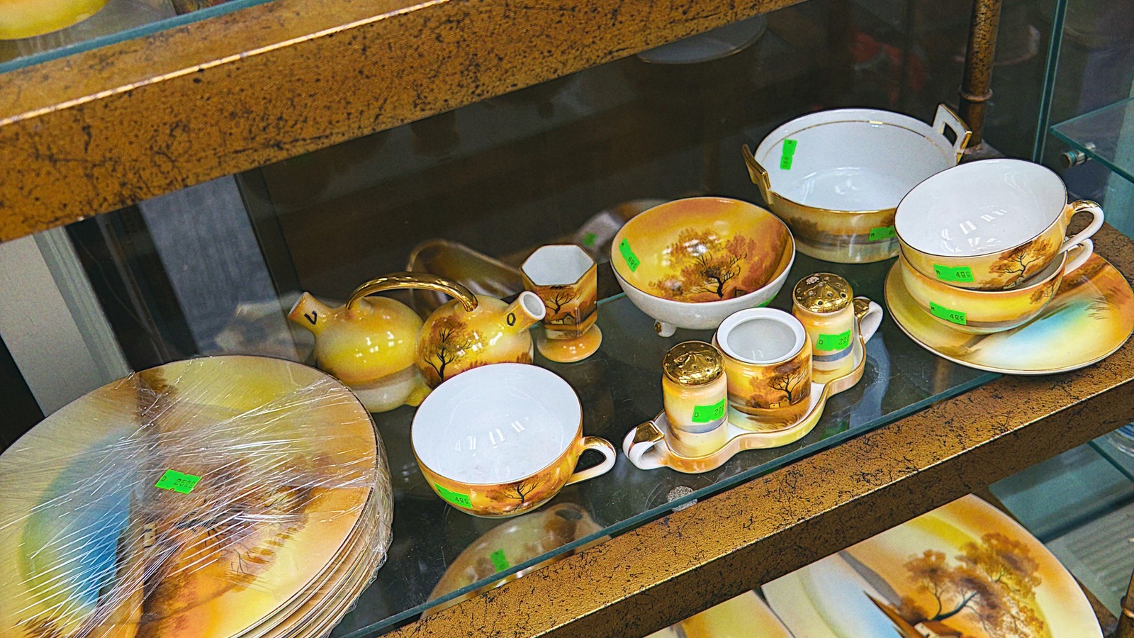 Teacups and decorative kitchenware arranged on a shelf at New Life Thrift