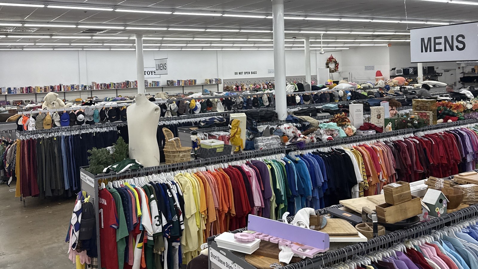 Color-organized clothing racks across the large Hialeah thrift store floor