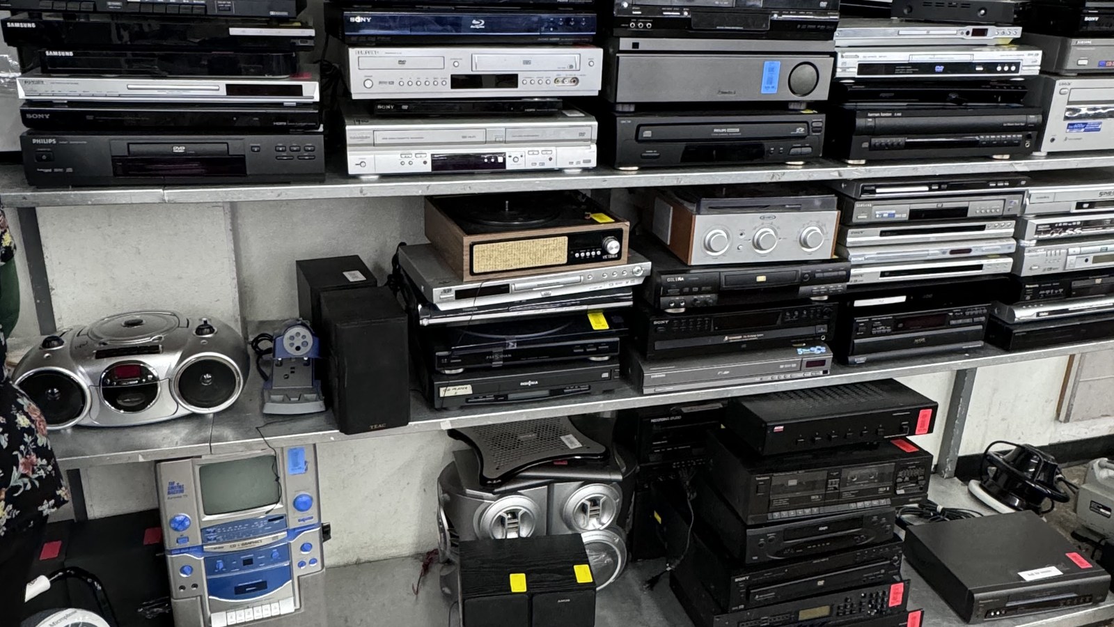 Stacks of vintage stereo components and radios at the Hialeah thrift store