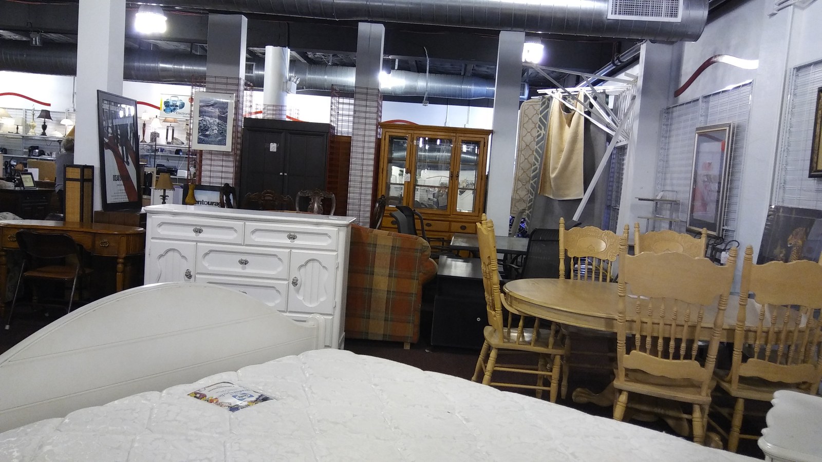 Dining sets, cabinets, and bedroom furniture on the Hialeah store floor