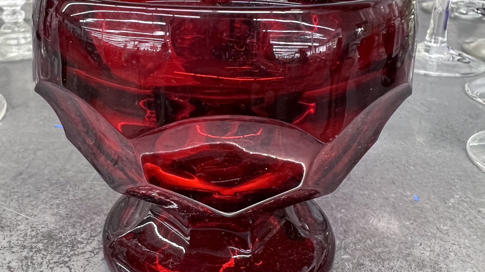 Deep red glass bowl on a housewares shelf in Hialeah