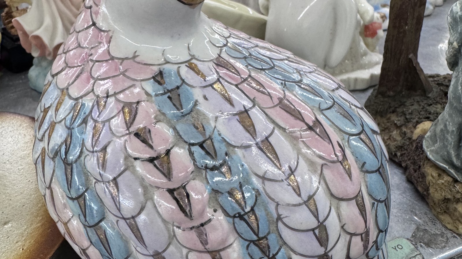 Pastel ceramic hen with feather details at the Hialeah thrift store