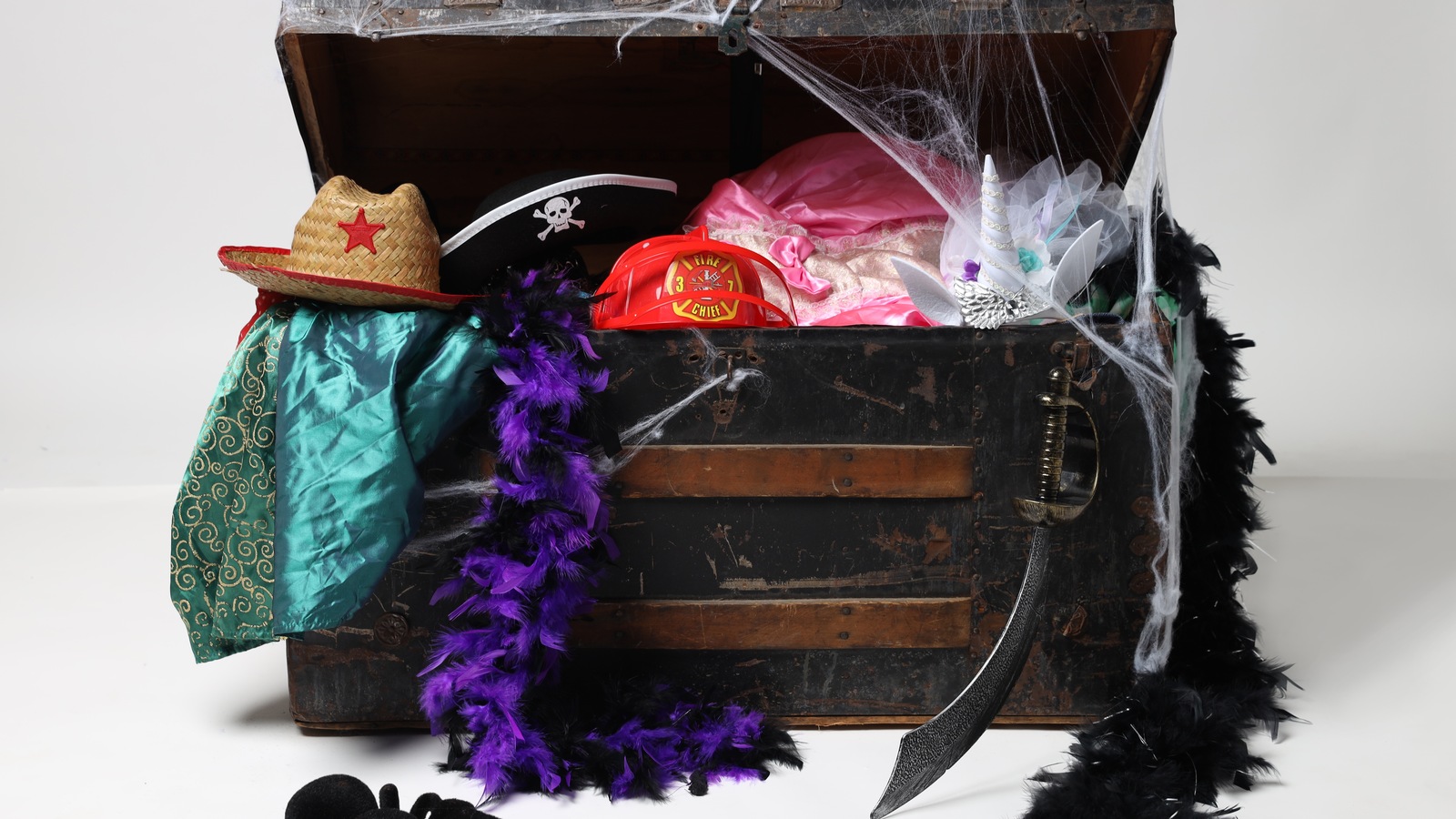 Costume accessories arranged around a vintage treasure chest in Jasper