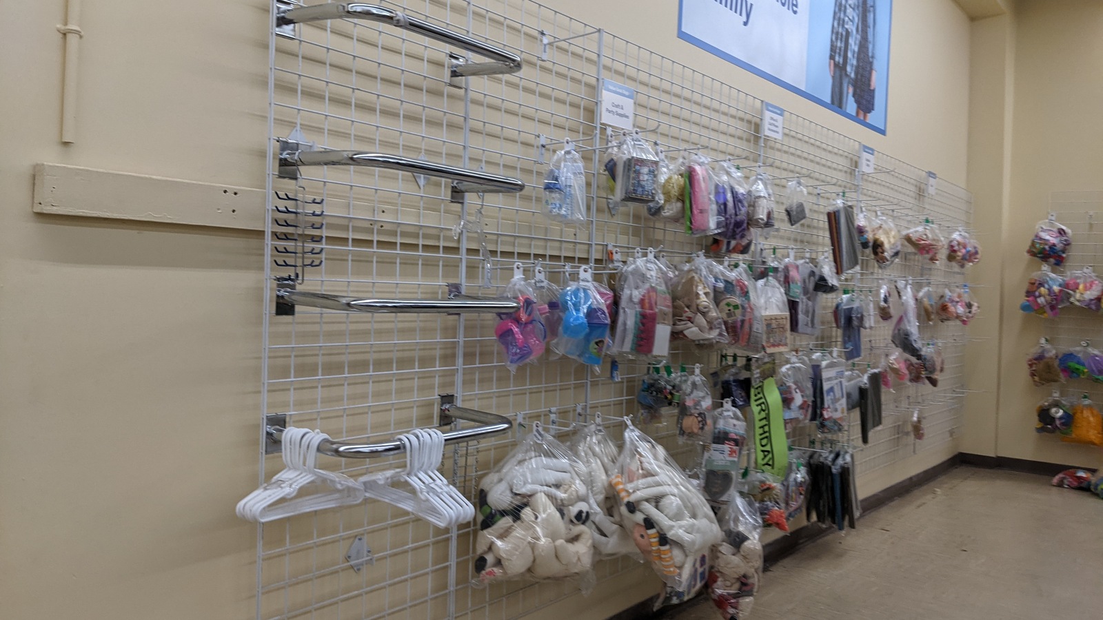 Accessories and small items displayed along a thrift store wall