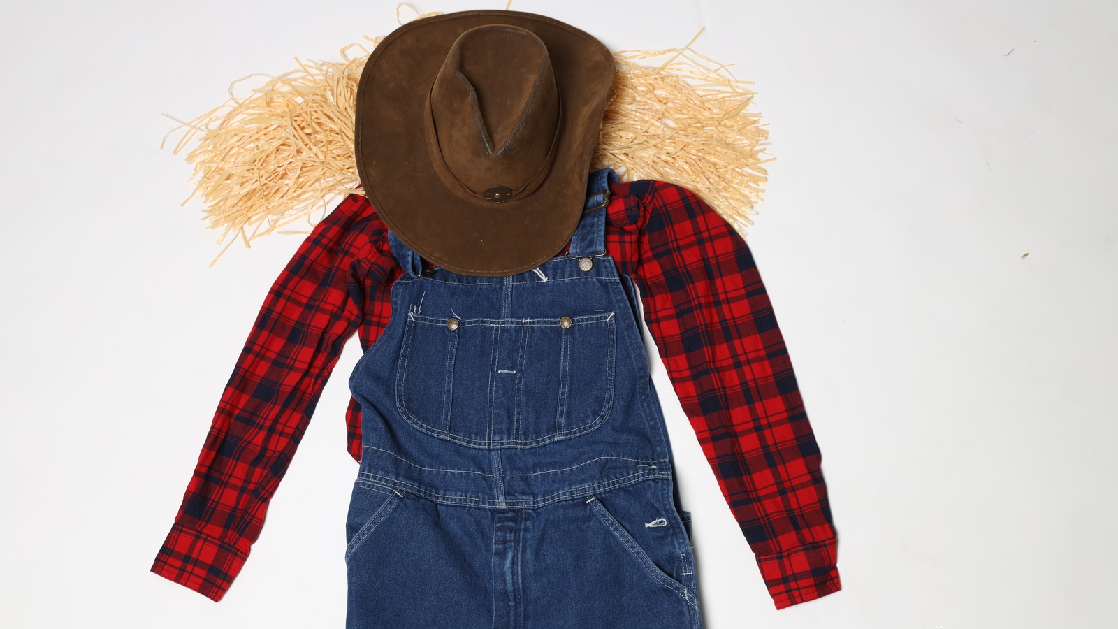 Scarecrow-inspired denim outfit arranged for a seasonal thrift display