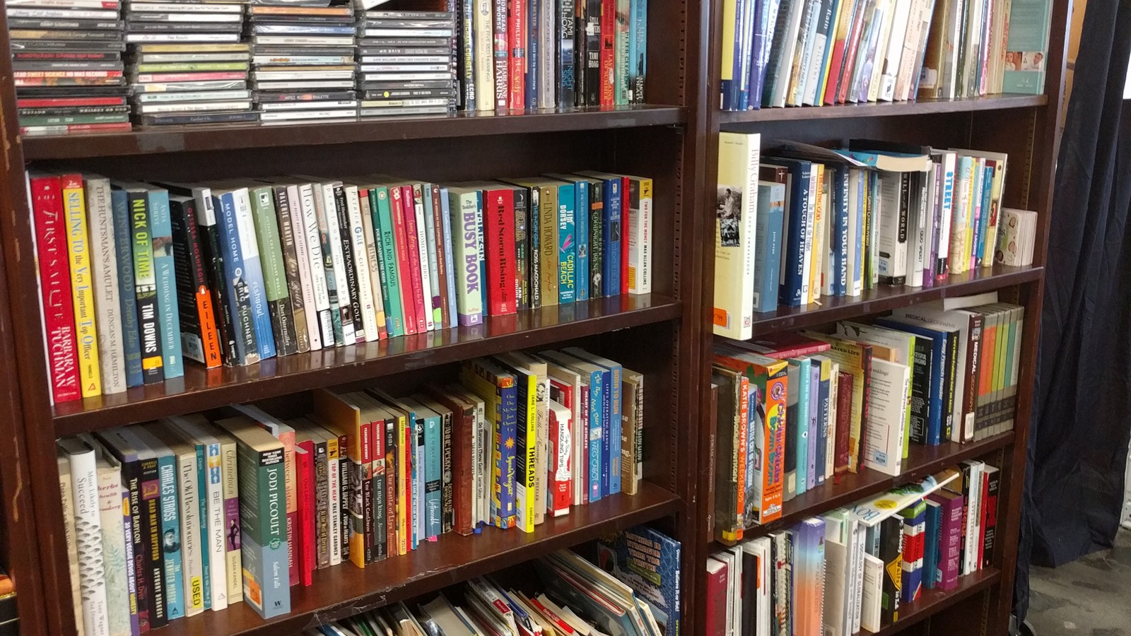 Shelves of books and media at ACTS Thrift Store in Pasadena