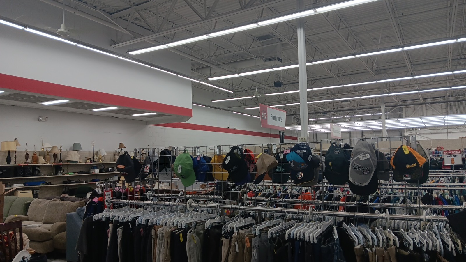 Hats and clothing racks across the ARC Thrift Store sales floor