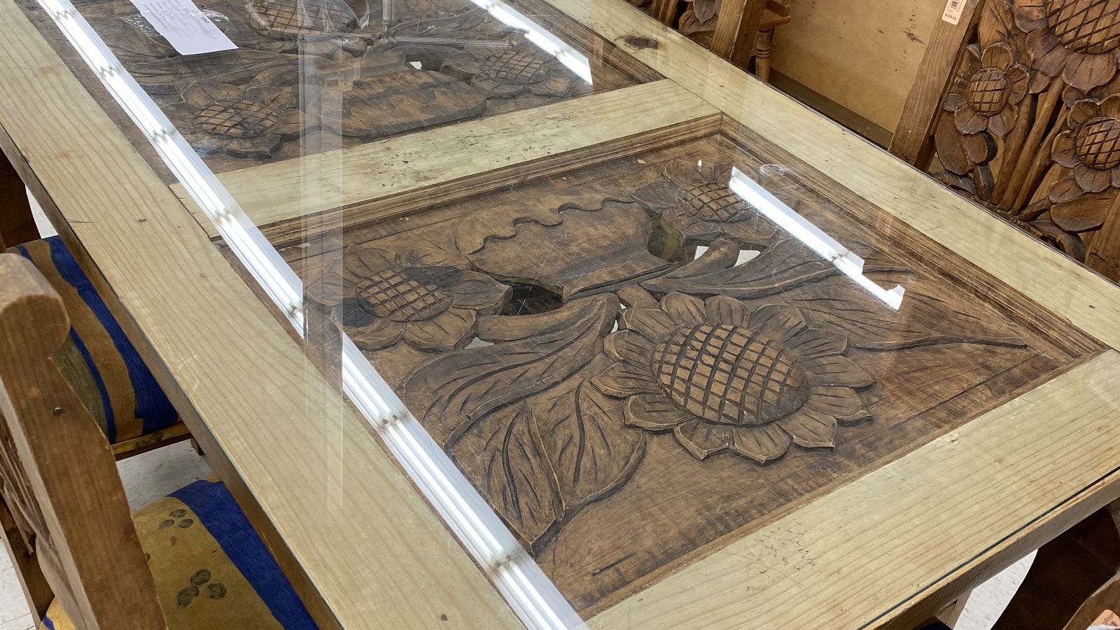 Carved wood tabletop with a detailed floral and fruit motif