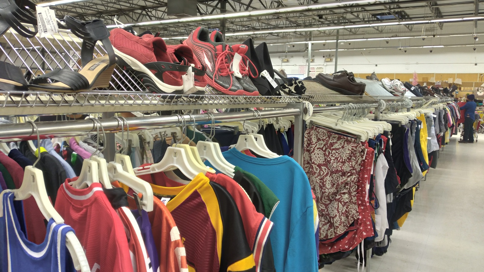 Colorful clothing racks and shoes inside Valley Thrift Store in Fairfield