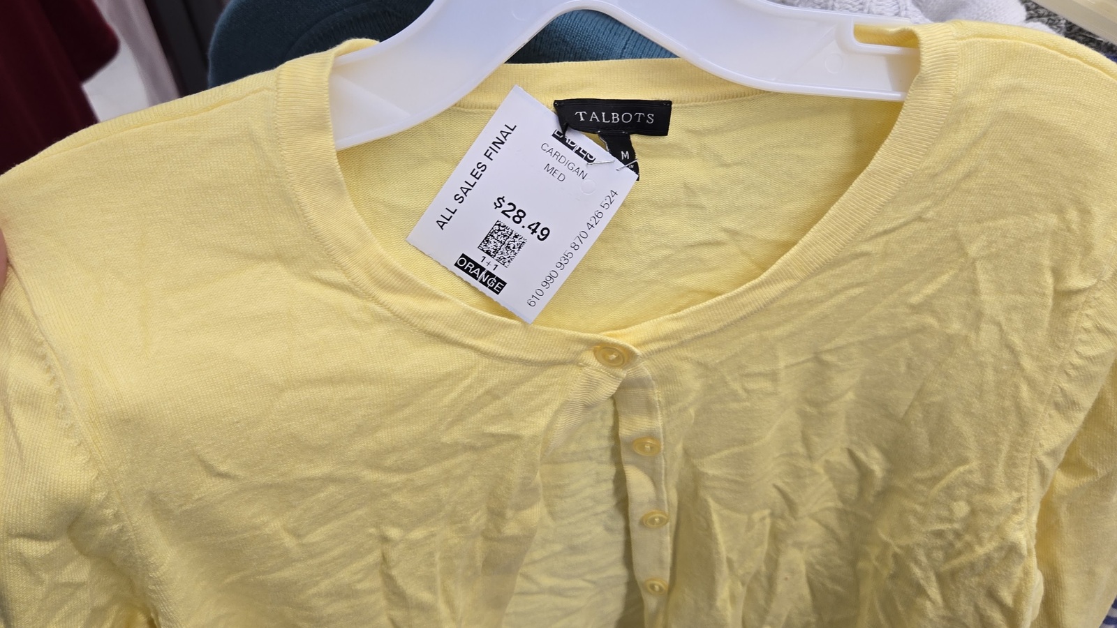 Yellow short-sleeve shirt on the clothing rack at Valley Thrift Store