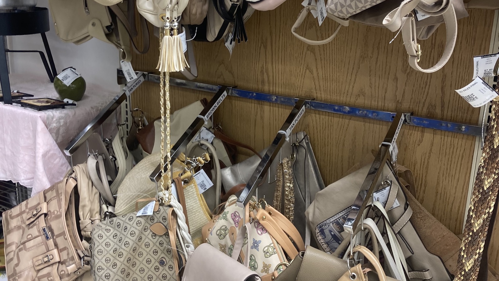 Handbags in varied colors and patterns displayed at Valley Thrift Store