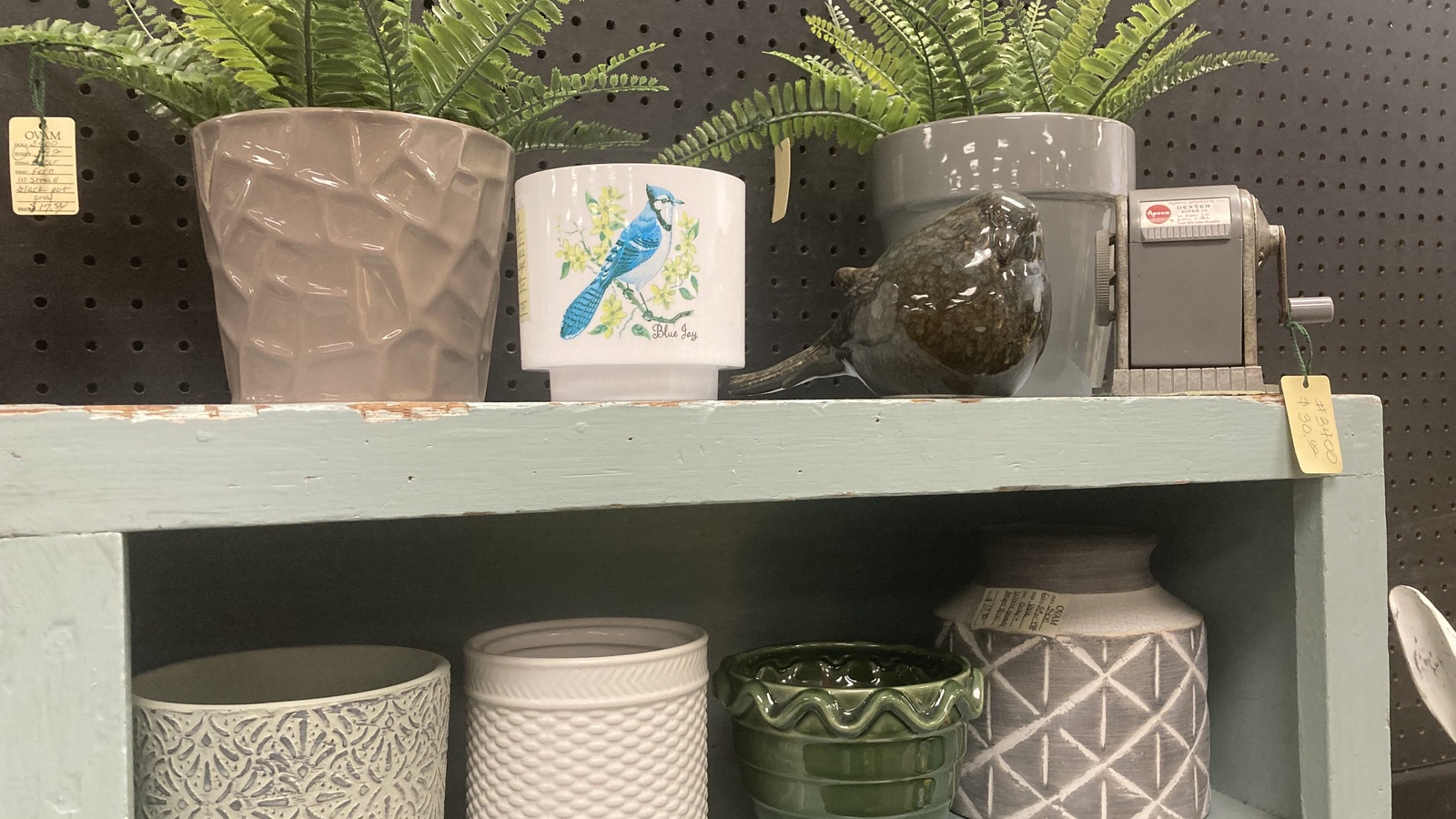 Decorative planters and small home accents on a shelf at Valley Thrift Store