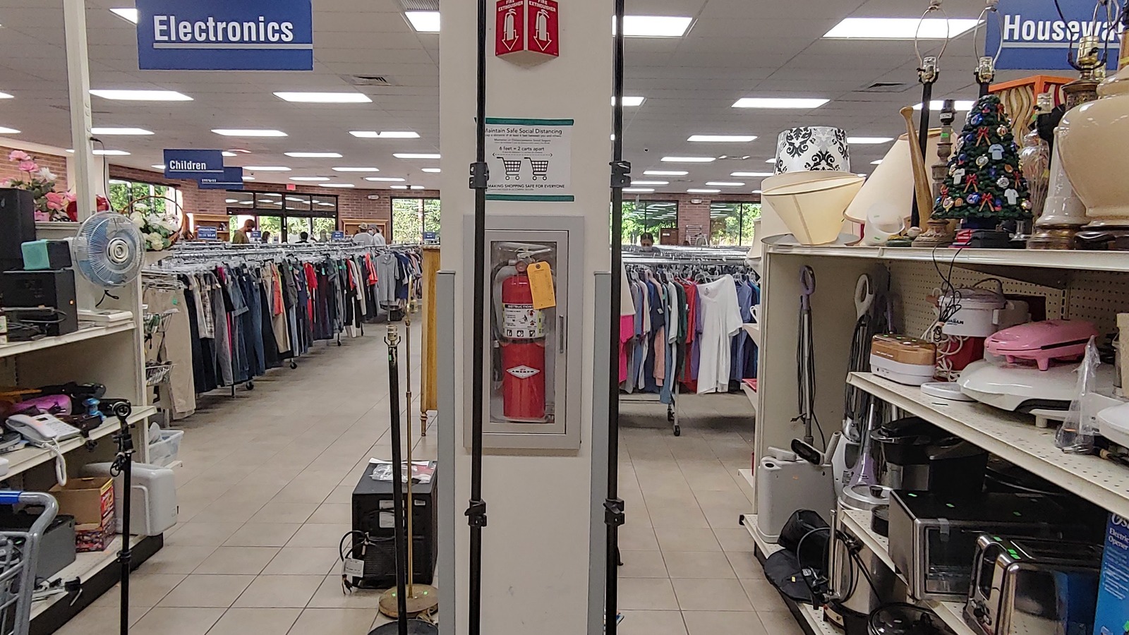 Clothing, housewares, lamps, and electronics arranged in aisles at the Waughtown Street Goodwill in Winston-Salem