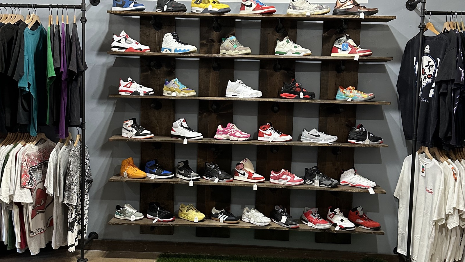 A colorful wall of vintage sneakers surrounded by shirts and streetwear inside Off The Rack in Winston-Salem