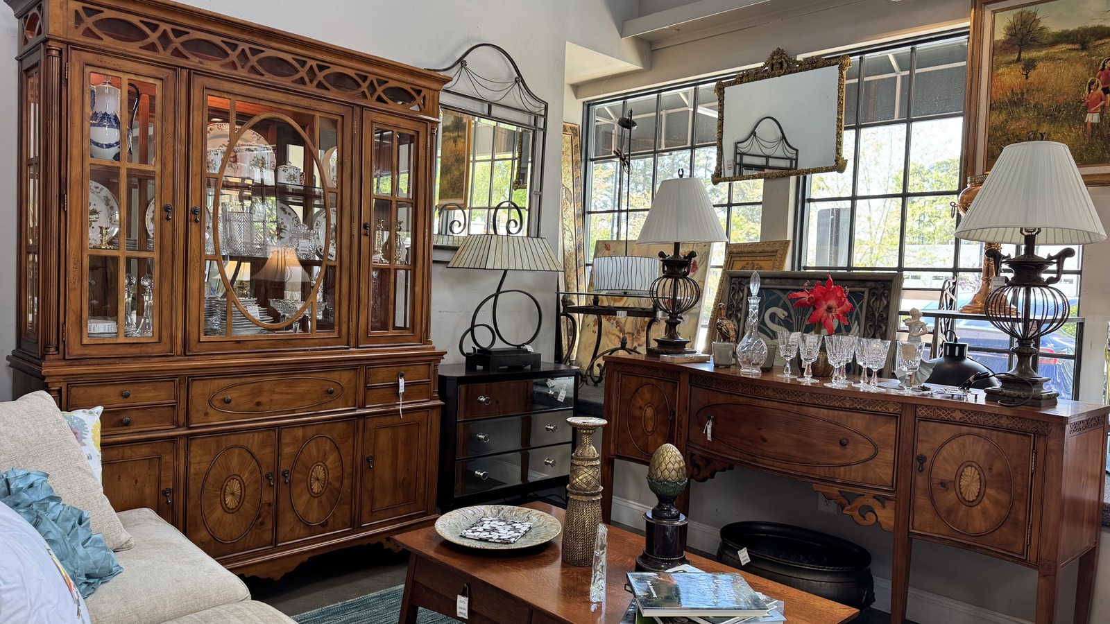 Wood furniture, lamps, and framed art inside The Velvet Shoestring in Williamsburg