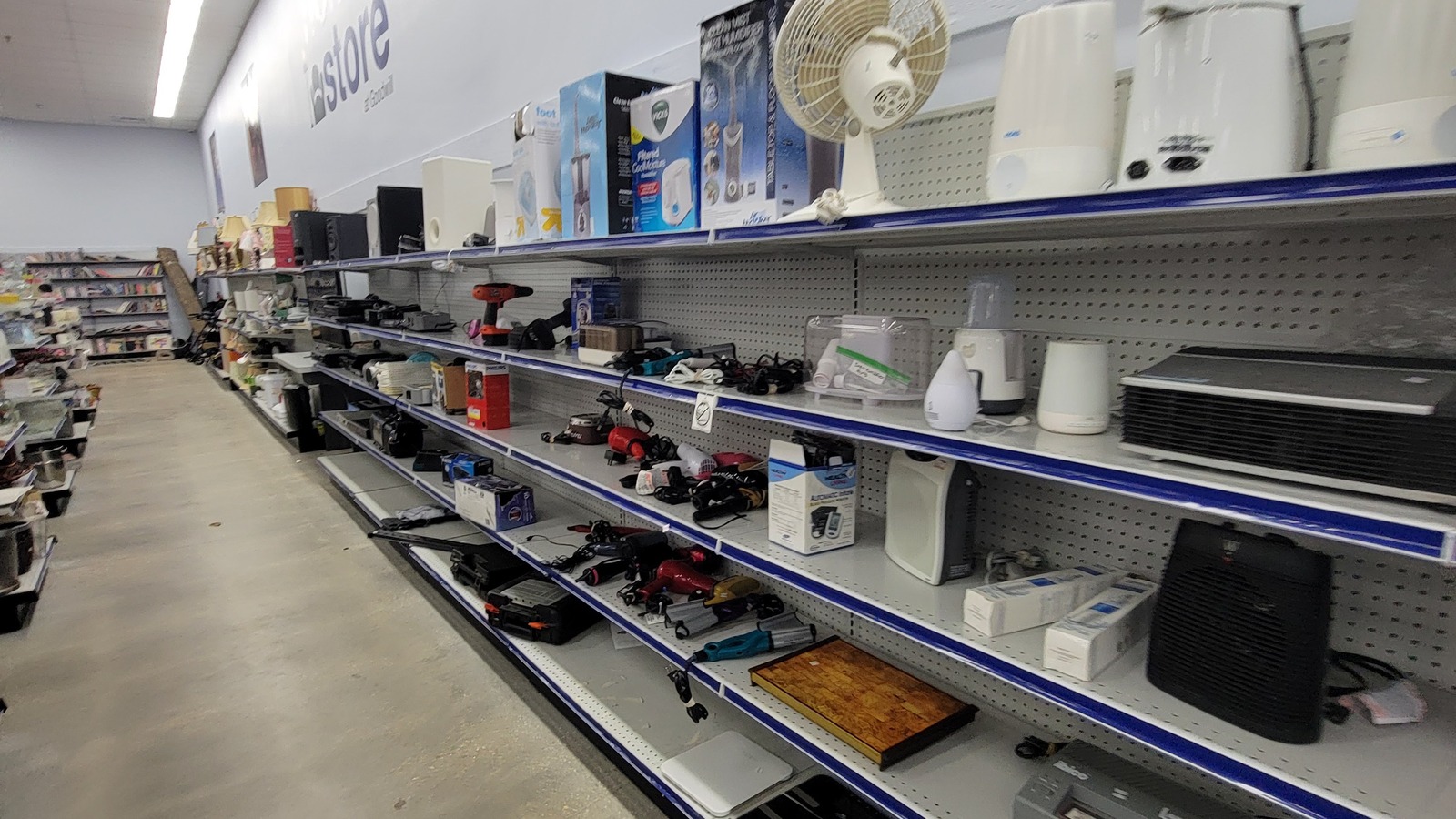 Neatly arranged housewares on open shelves at Goodwill in Williamsburg