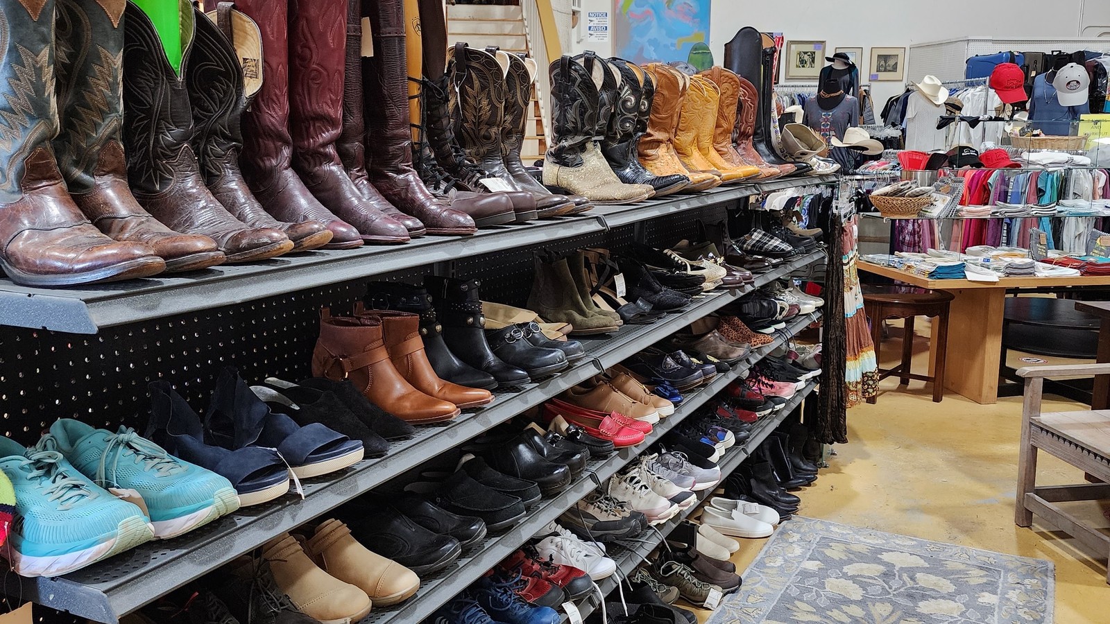 Shelves of riding and Western boots at The Horse Shelter Resale Store