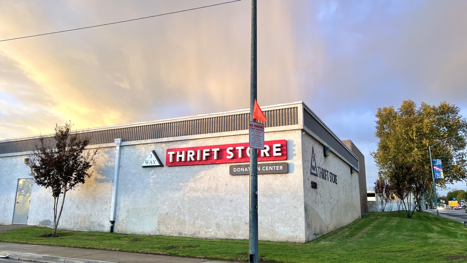 Donation center side of 3 Way Thrift Store at sunset