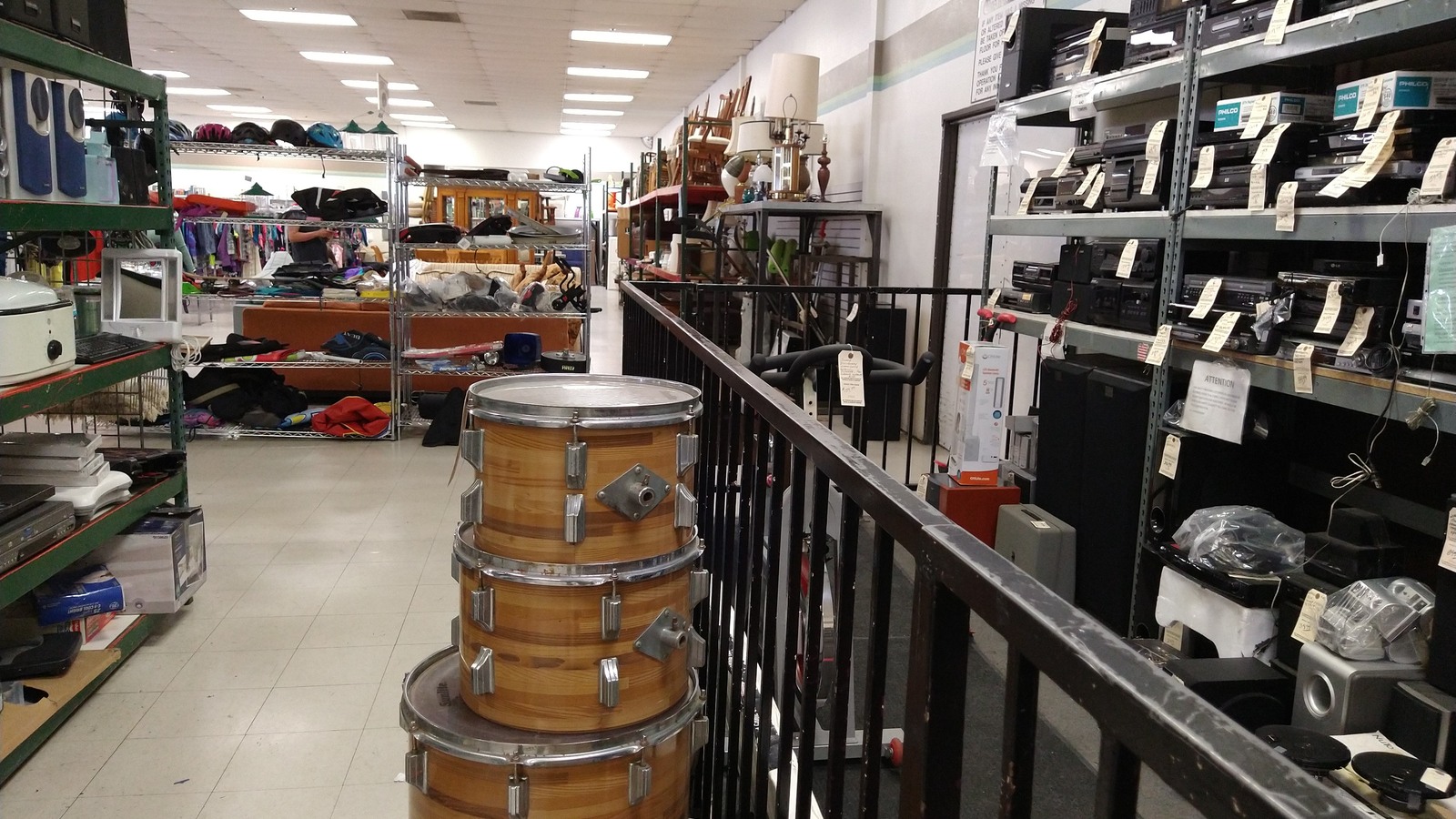 Shoes and handbags arranged along shelves in the Montclair thrift store