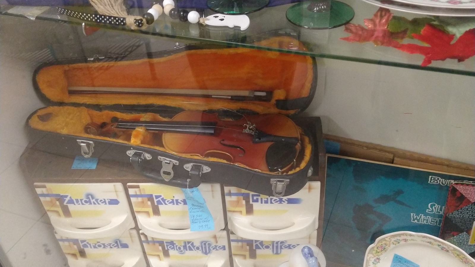 Two violins in cases among collectible pieces at Quality Thrift Store