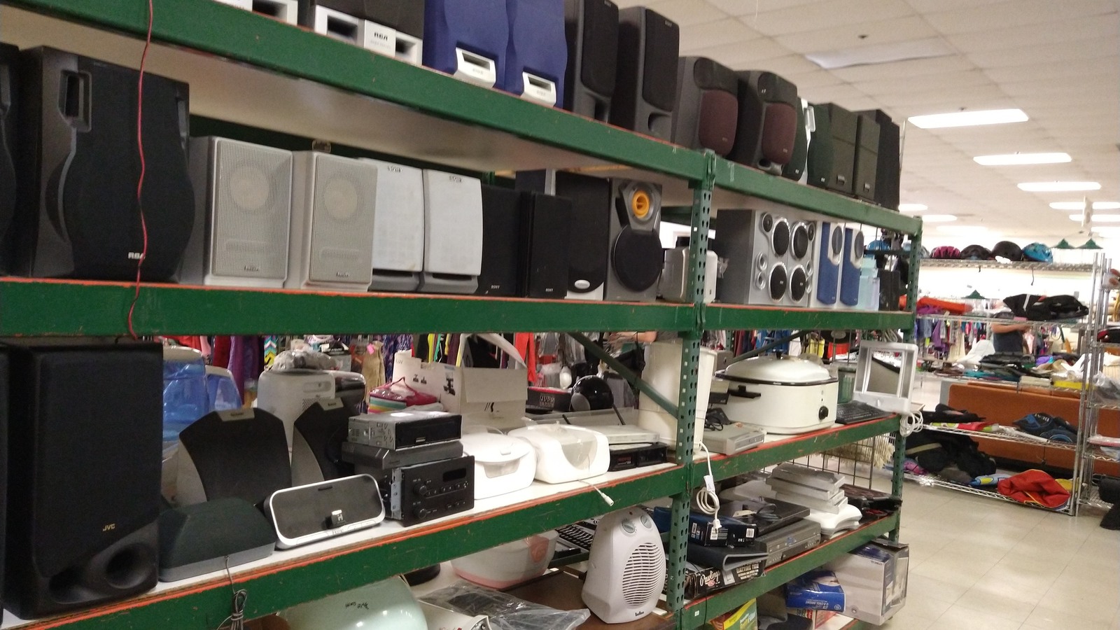 Small appliances, speakers, handbags, and everyday accessories on shelves