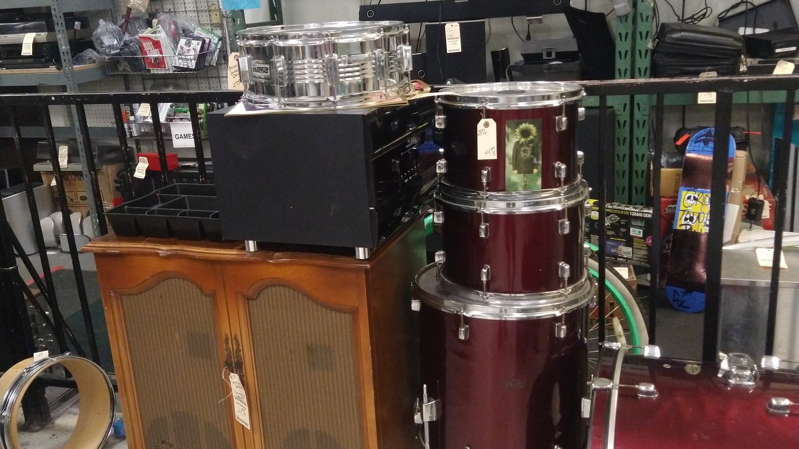 Red drum set and musical gear on the Quality Thrift Store sales floor