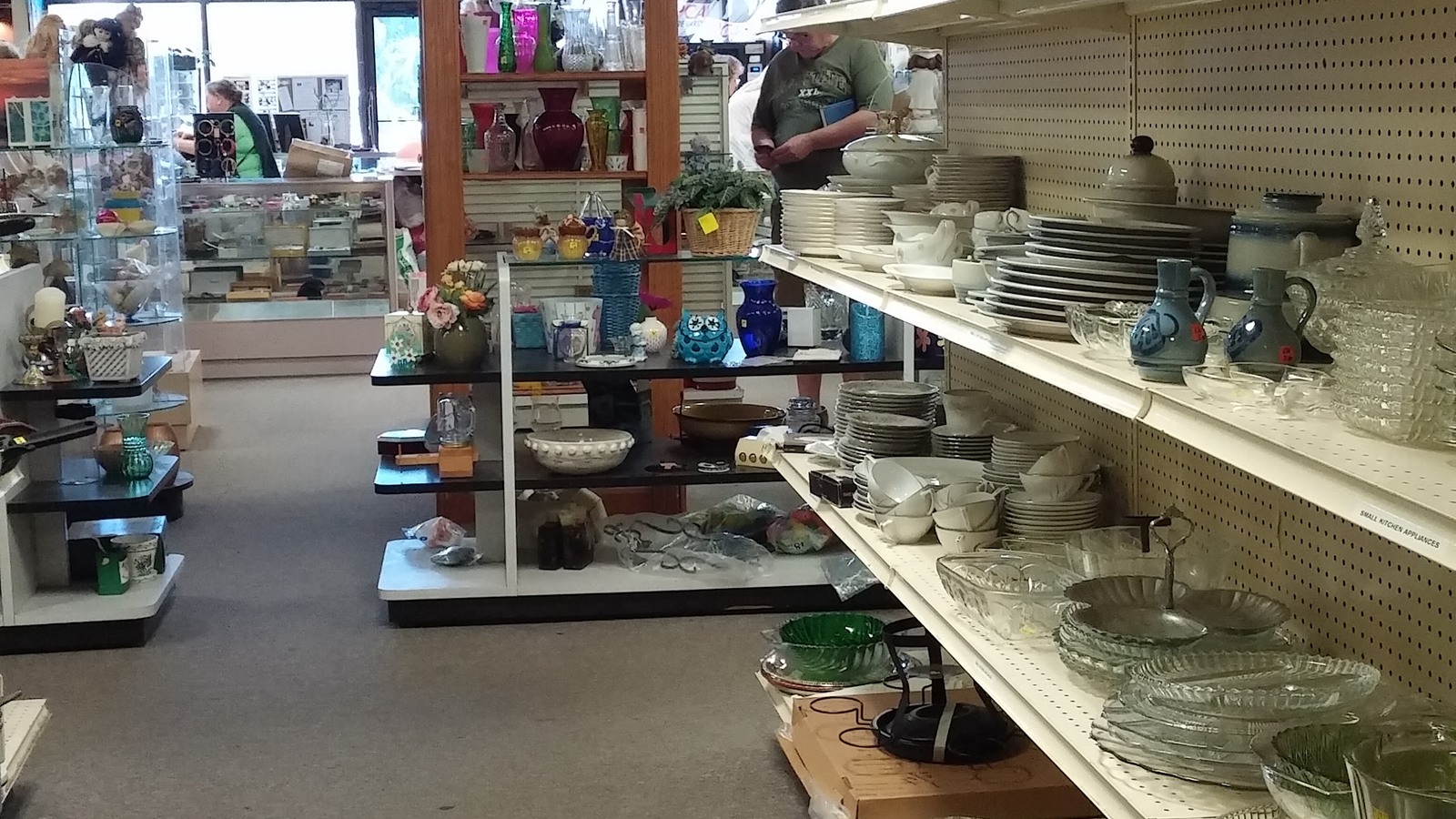 Dishes, glassware, and decorative pieces lining store shelves