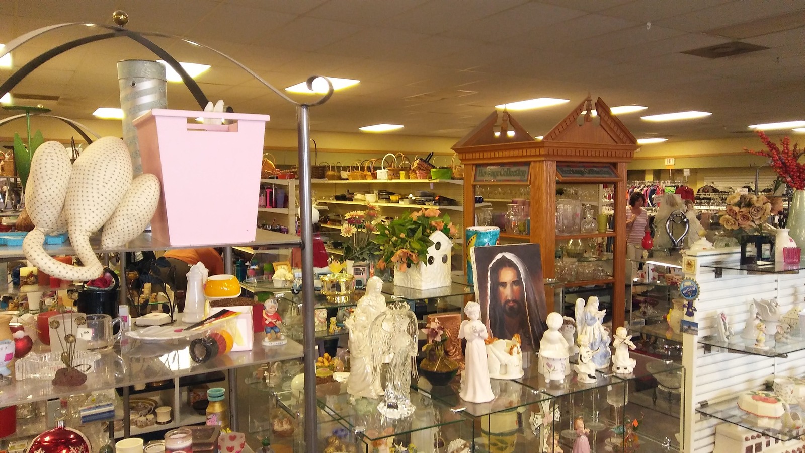 Figurines and decorative collectibles gathered around a wood display case