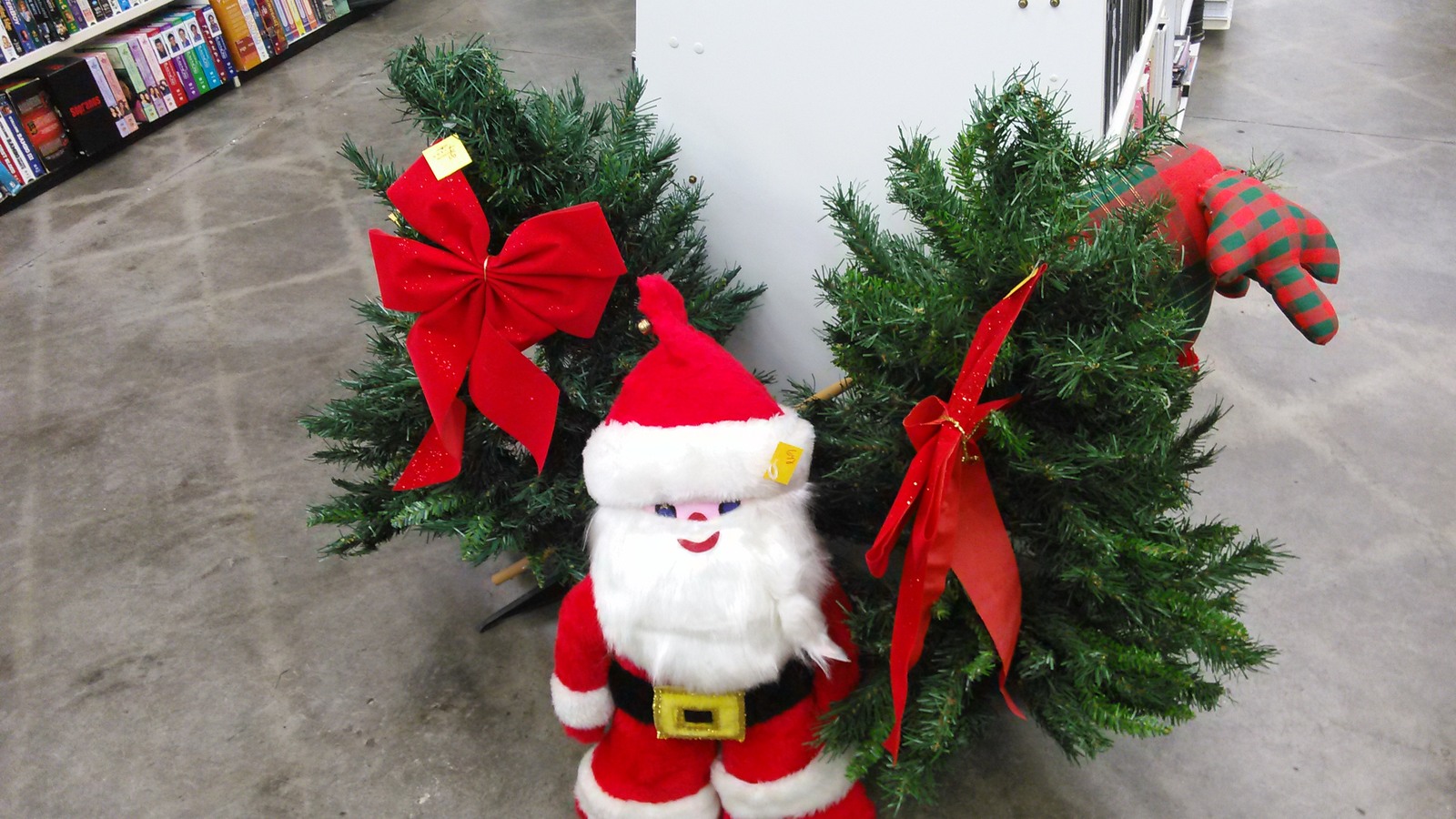 Green holiday wreaths with red bows and a Santa decoration
